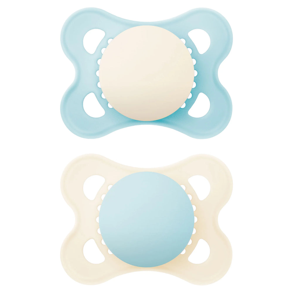 Two baby pacifiers, one blue and one beige, on a white background