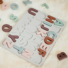 Silicone alphabet learning toy with letters scattered around
