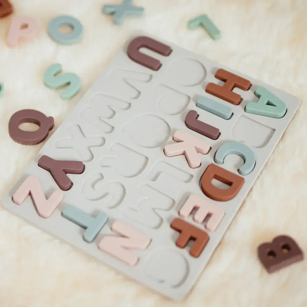 Silicone alphabet learning toy with letters scattered around