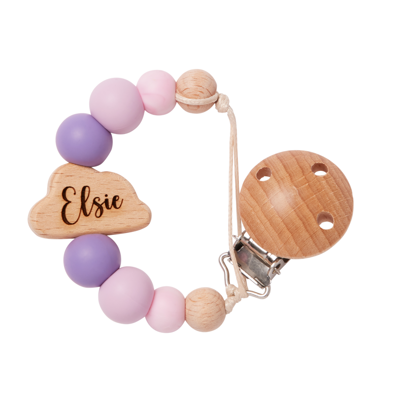 Teething ring with pruple and pink beads and wooden components on a white background engraved with name 'Elise'
