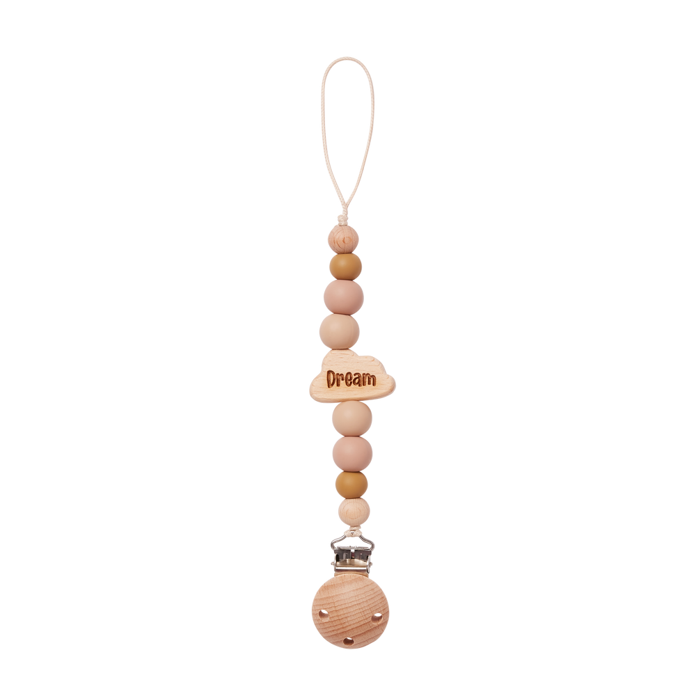 Wooden pacifier clip with beads in beige and 'Dream' charm on a white background