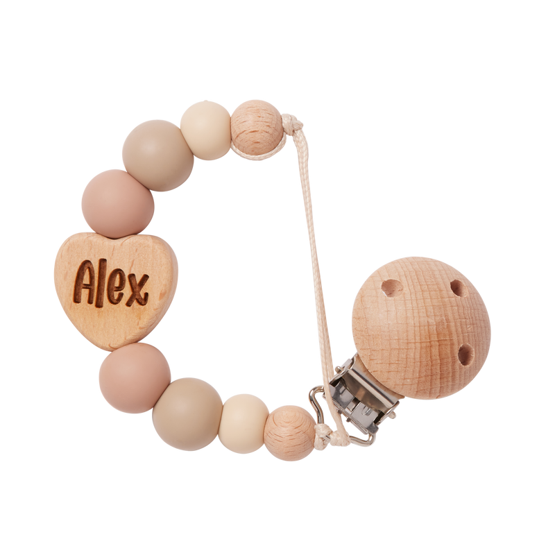 Personalised dummy clip with food grade silicone beads and a heart-shaped charm engraved with 'Alex' on a white background.