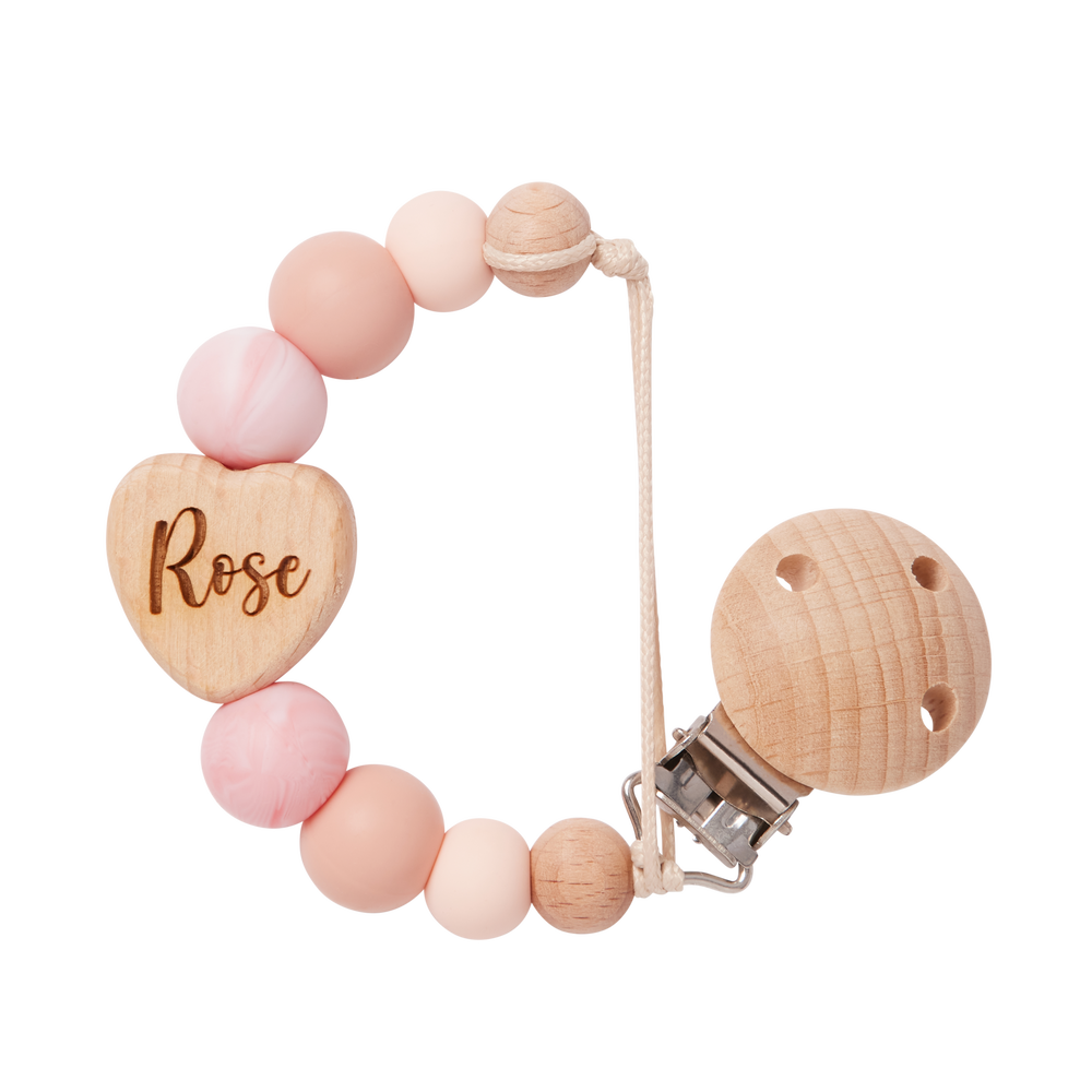 Personalised Dummy Clip with pink and peach beads and a heart-shaped wooden piece engraved with 'Rose'.