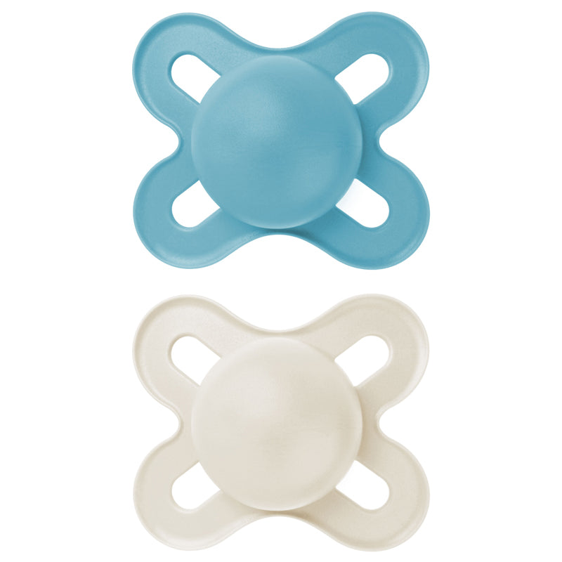 Two baby pacifiers, one blue and one white, on a white background