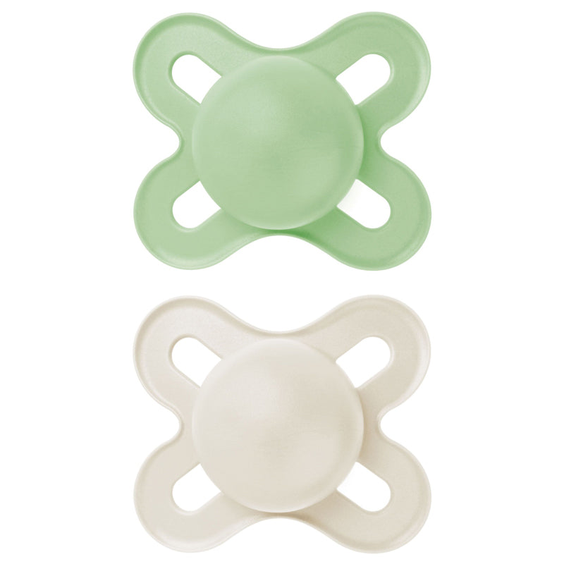 Two green and white MAM baby pacifiers dummies on a white background