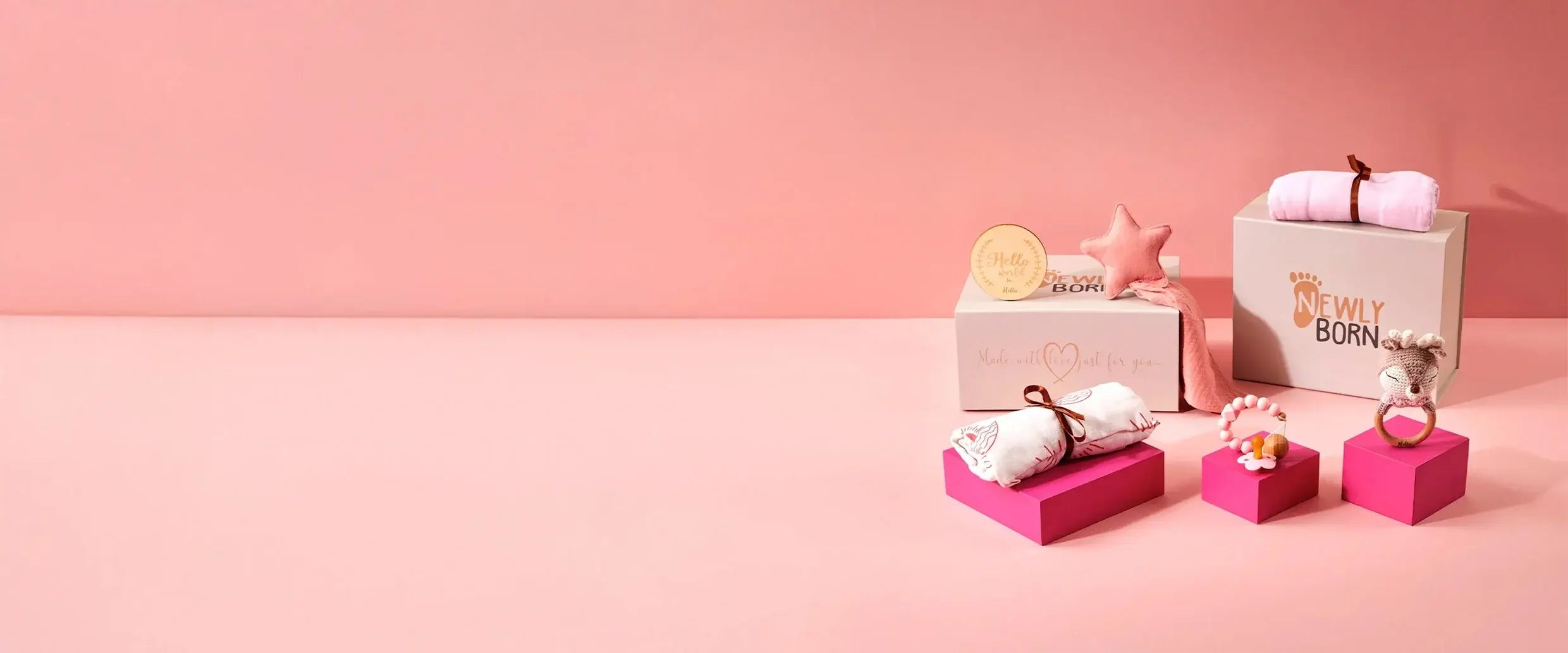 Personalised baby gifts on pink plinth and pink background with Luxury gift box