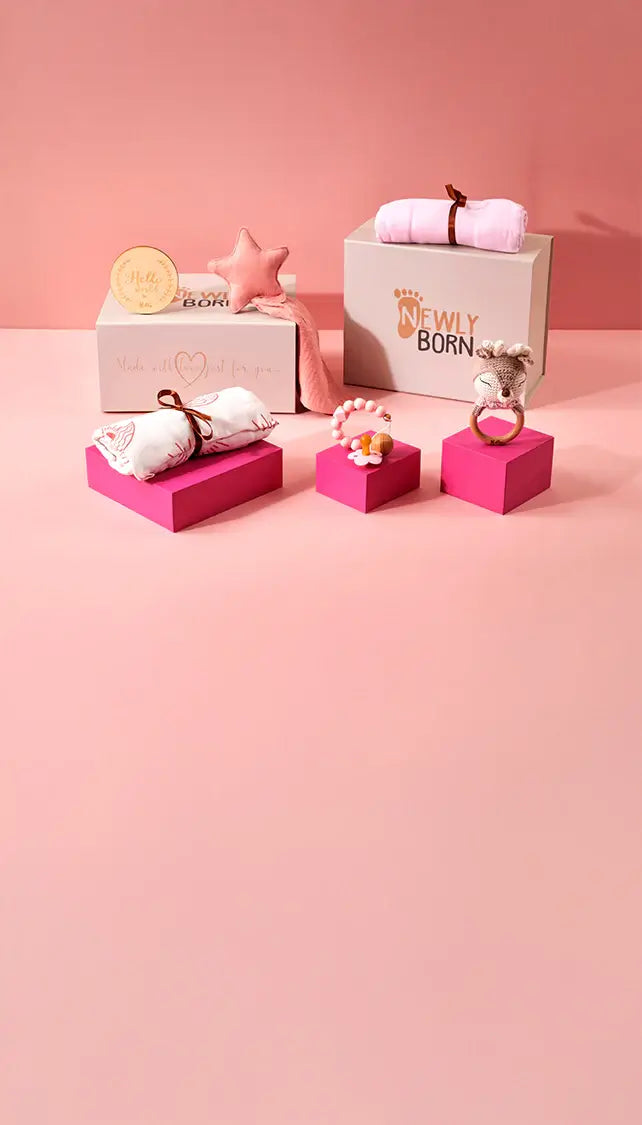Personalised baby gifts on pink plinth and pink background with Luxury gift box