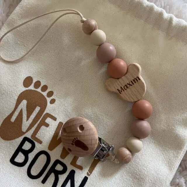 Personalised bear dummy clip in neutral colour 5 star review newly born packaging background