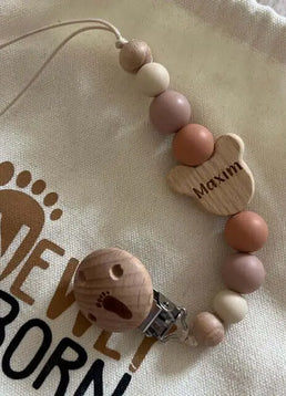 Personalised bear dummy clip in neutral colour 5 star review newly born packaging background